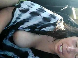 Blonde bombshell indulges in tit play while driving