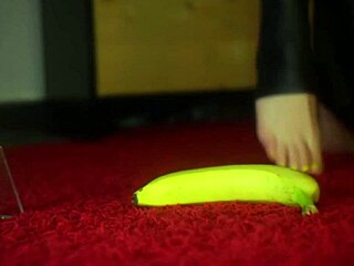 Jelisa Rose's feet playing with a banana in a yellow submarine setting