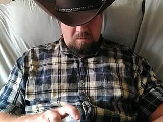 Cowboy strokes his cock to orgasm, building up a massive load
