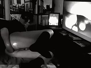 Gay man engages in self-fisting and anal play in a dark room