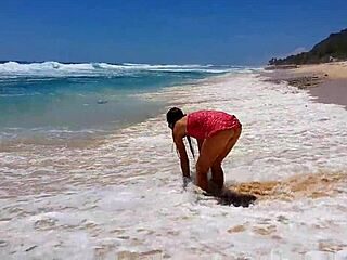 Sandy beach fun with red butt plug and perfect pussy