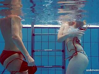 Marusia and Melisa Darkova strip and tease as underwater lesbian babes by the pool.
