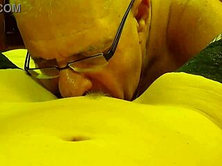 Husband dives into wife's pussy between spreading legs.