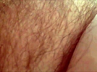 Amateur milf rubs her hairy pussy at home