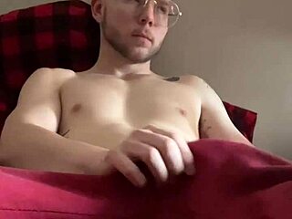 A young gay man masturbates while watching his own POV video.