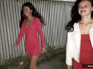 Curly brunette girlfriends share intriguing public pee near car in outdoor parking lot