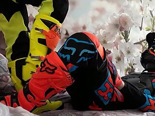 Gay biker treads boots in motocross costume?