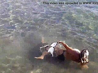 Milf playing with her candy body on public beach