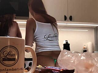 Young wife doing the dishes on a surveillance camera