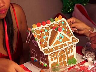 Two girls have fun making a ginger bread house during Christmas 2024 holiday