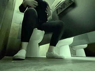 Girl enjoys solo play in public restroom's anonymity