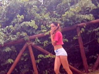 A naughty girl gets a handjob in a public place
