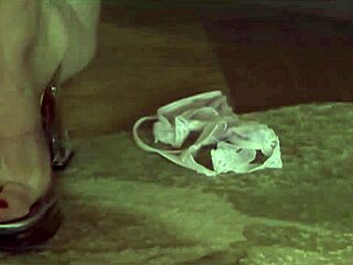 Lesbian friends play with sex toy in cozy living room