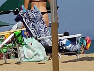 Hidden candid video of a young woman in bikini on the beach