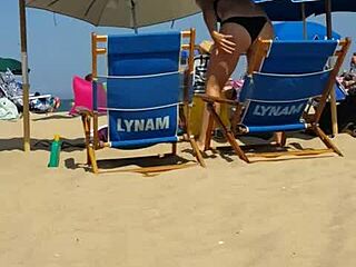 Hidden candid video of a young woman in bikini on the beach