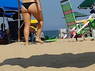 Hidden candid video of a young woman in bikini on the beach