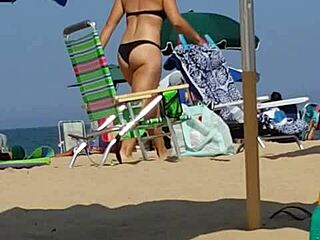 Hidden candid video of a young woman in bikini on the beach