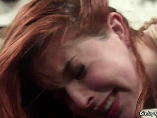 Busty lesbian dominates by fucking and whipping bound redhead slave with strapon.
