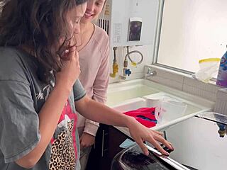 Two lesbians share a quiet moment in the kitchen.