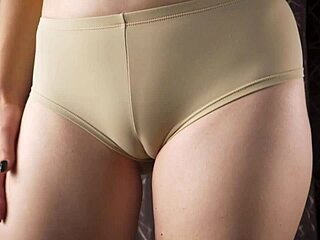 Enjoy a close-up tease of camel toe in vintage panties with belly and pussy lips