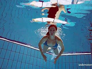 Brunette teen Martina swims underwater in blue bikini at the beach. Her tight pussy shows through in outdoor European pool shower.