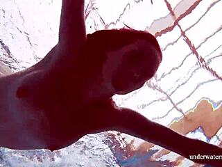 Brunette teen Martina swims underwater in blue bikini at the beach. Her tight pussy shows through in outdoor European pool shower.