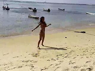 Monika Fox poses solo in pink bikini on beach