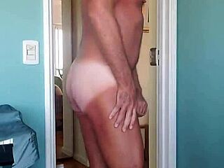 Pervy bodybuilder gropes his bulging cock in soft cotton muscle shorts